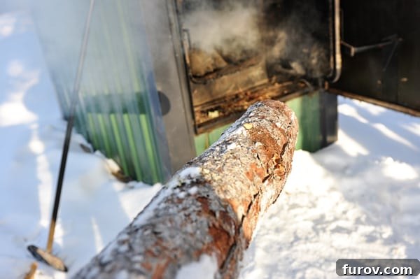 Snapshot Saturday: A Slice of Life 7 A pile of neatly stacked firewood, ready to be loaded into Freddie Heatmor, the outdoor wood furnace, highlighting the effort involved in sustainable home heating.