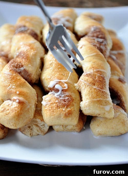 Cinnamon and sugar breadsticks with a light glaze over the top.