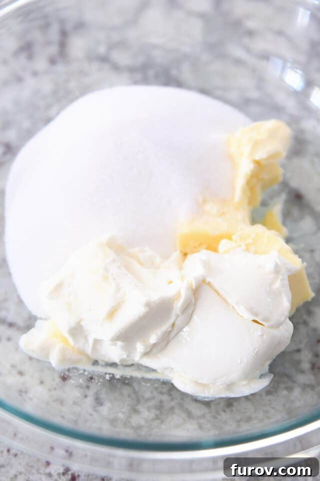 Cream cheese, butter and granulated sugar in glass bowl, ready to be creamed together for banana bread batter.