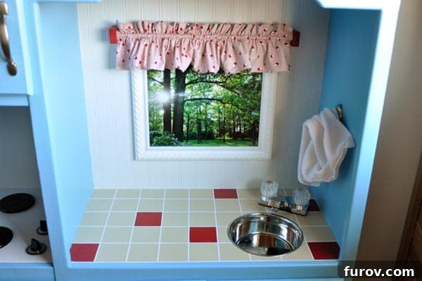 Play kitchen window with miniature curtains and a family photo