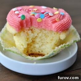 A beautifully decorated yellow cupcake, ready for baking.