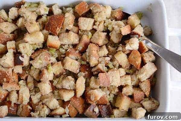 Top view of a white ceramic baking dish filled with classic Thanksgiving stuffing.