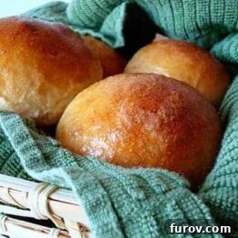 A plate of golden brown Thanksgiving rolls, ready to serve.