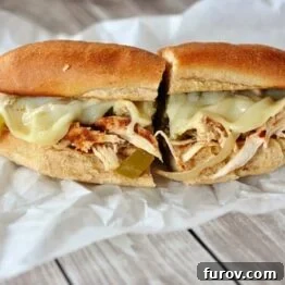 Close-up of a Slow Cooker Chicken Philly Sandwich with melted cheese