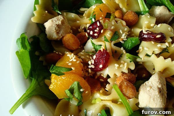Close-up of a vibrant serving of Spinach Chicken & Pasta Salad with Teriyaki Vinaigrette.