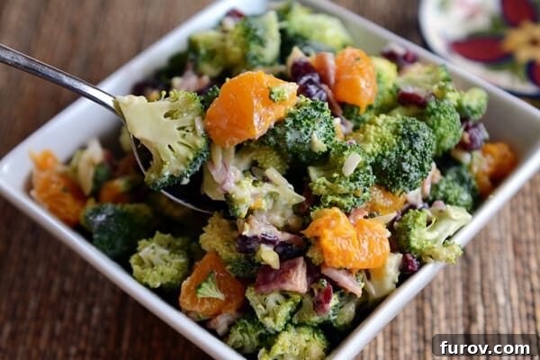 Zesty Mandarin Broccoli Salad 4 A white square dish full of mandarin broccoli salad.
