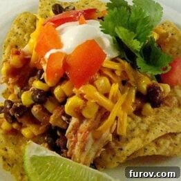 Close-up of shredded chicken, corn, and black beans mixture in a slow cooker, ready to be served.