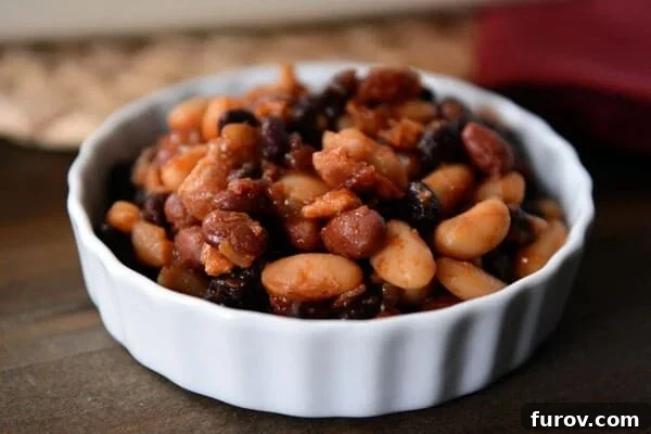 Mom's Legendary Calico Baked Beans 4 A white ramekin brimming with perfectly baked Calico beans and crispy bacon bits.