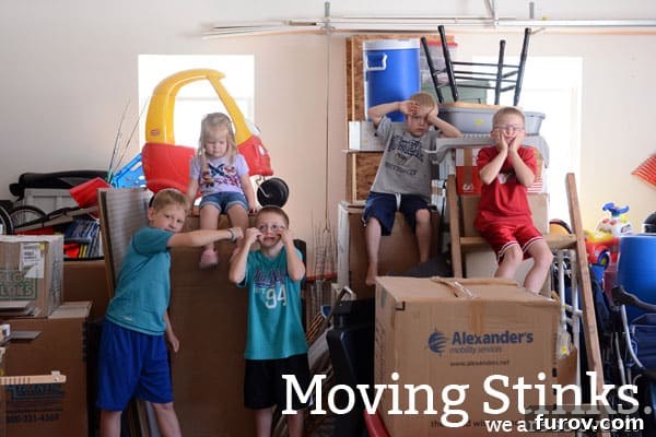 Five excited children making silly faces amidst moving boxes, symbolizing a family's journey to a new home.