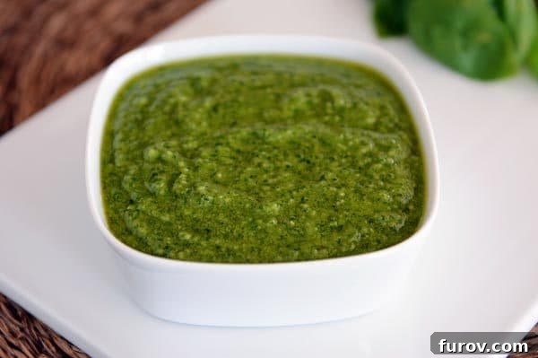 A white square dish full of basil pesto. 