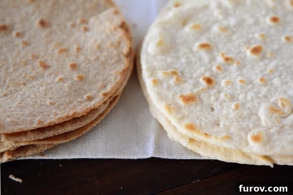 Two stacks of whole wheat and white flour homemade tortillas.
