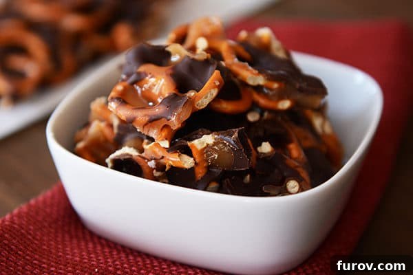 Homemade Dark Chocolate Sea Salt Caramel Pretzel Bark 4 A white ramekin brimming with bite-sized chunks of dark chocolate sea salt caramel pretzel bark, perfect for sharing.