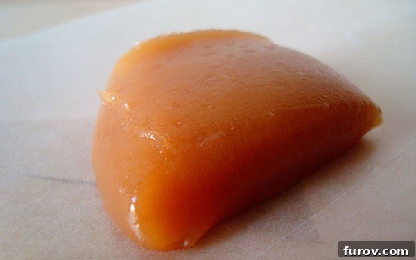 My Mom's Famous Caramels 3 Close-up of a lump of luscious light brown caramel, showcasing its smooth texture.