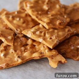 Close-up of Maple-Spice Cashew Brittle pieces, showcasing the texture and cashews