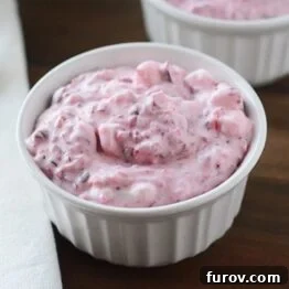 A small bowl of Cranberry Fluff Christmas Salad, showing its creamy texture and vibrant color.