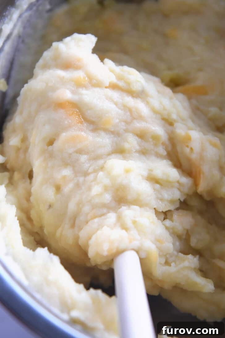 Rustic Meat and Potato Pie 4 Top-down view of an Instant Pot filled with creamy, cheesy mashed potatoes, indicating a rich and smooth topping for the Shepherd's Pie.