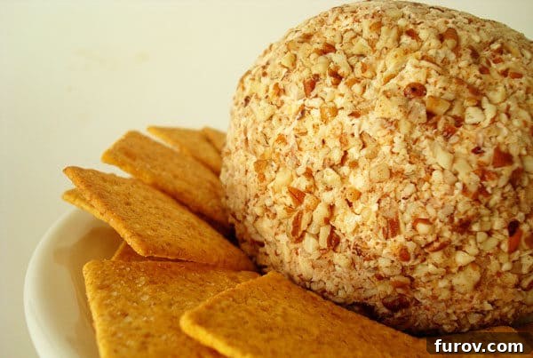 cheeseball and crackers on a white plate