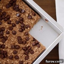 A close-up shot of a banana bread chocolate chip oat snack bar.