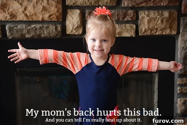 A little girl holding her arms out wide and smiling.