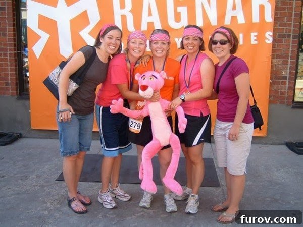 The Chronicle of Mel 5 A group of ladies holding a large stuffed Pink Panther, capturing a moment of joy and camaraderie, possibly after a race.