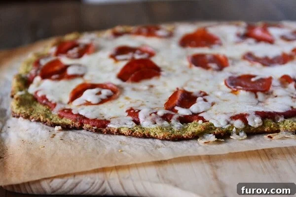 Wholesome Zucchini Pizza Base 4 A zucchini crust pepperoni pizza on a piece of parchment.