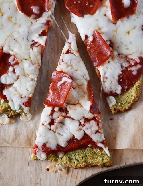 Wholesome Zucchini Pizza Base 6 Top view of a zucchini crust pepperoni pizza with a slice cut out.