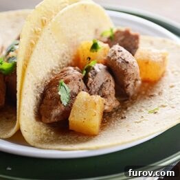 Sweet and Spicy Pork and Pineapple Tacos, showcasing the rich colors of the ingredients.