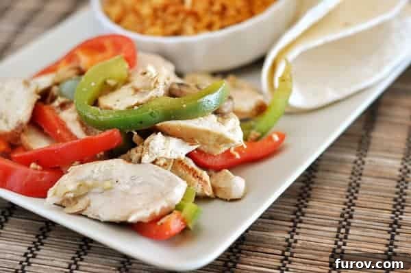 White platter with fajita chicken strips, and pepper strips.