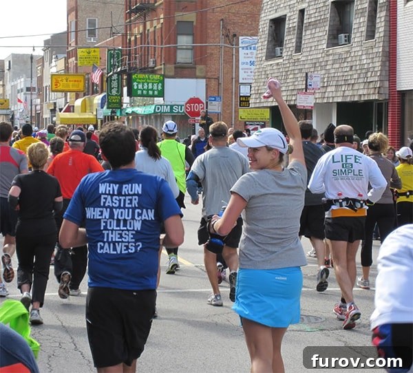 A large crowd of enthusiastic participants running the Chicago Marathon, showcasing the vibrant atmosphere and sense of community.