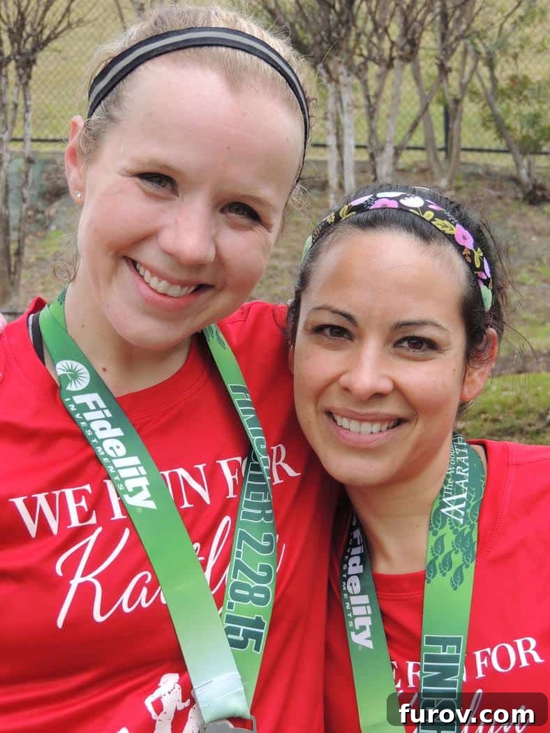 Two triumphant women, Shelly and a friend, wearing race medals around their necks, beaming with pride.
