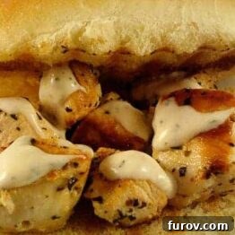 Grilled chicken pieces on skewers, ready to be put into sandwiches.