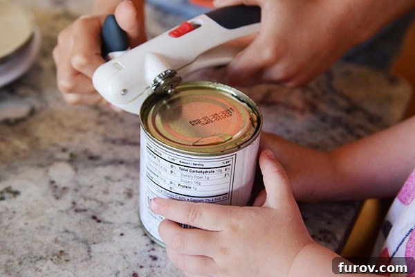 A can opener opening a can.