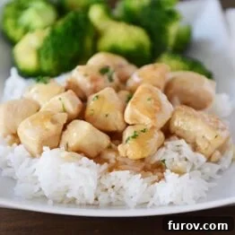 Skillet Lemon Glazed Chicken on a white plate with rice and broccoli.