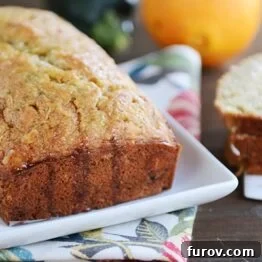 A small, cropped image of a slice of orange zucchini bread.