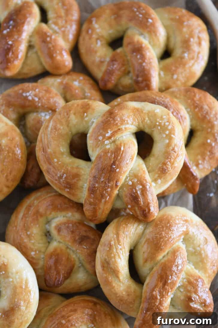 Pillowy Soft Homemade Pretzels 2 A stack of several perfectly baked homemade soft pretzels, generously sprinkled with coarse salt.