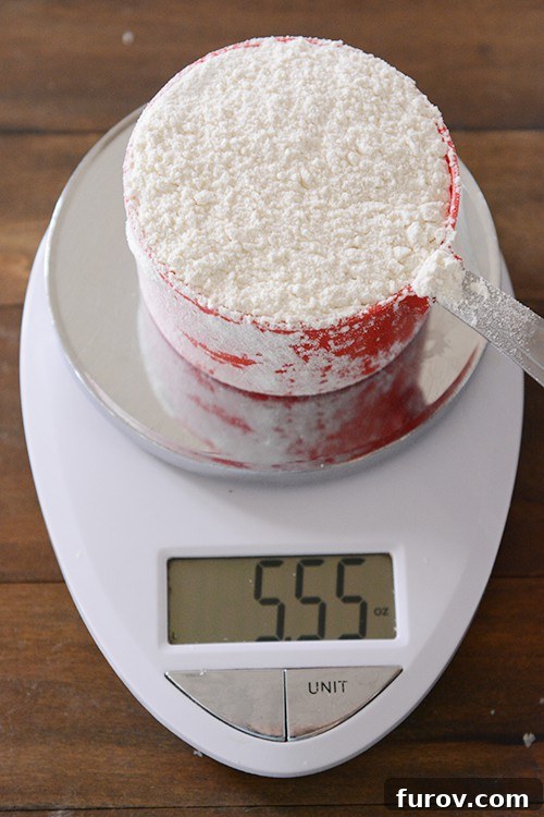 Top view of a red measuring cup on a kitchen scale. 