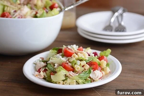 Portillos Iconic Chopped Salad with Signature Sweet Italian Dressing 3 A white plate of Portillo's chopped salad.