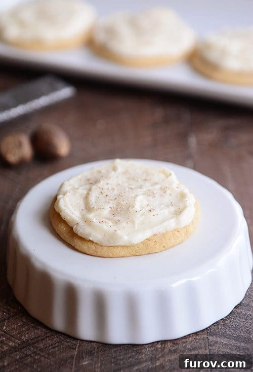 A beautifully frosted soft eggnog sugar cookie, ready to be enjoyed.