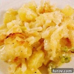 Delmonico Potato Bake, a creamy potato casserole with a golden, crispy topping, ready to be served as a delicious side dish.