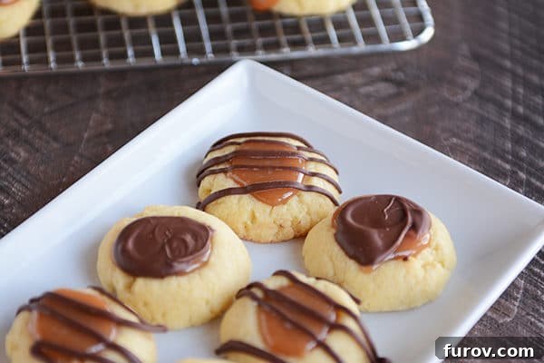 Caramel Chocolate Shortbread Delights 3 Chocolate and caramel topped shortbread cookies on a white rectangular platter.