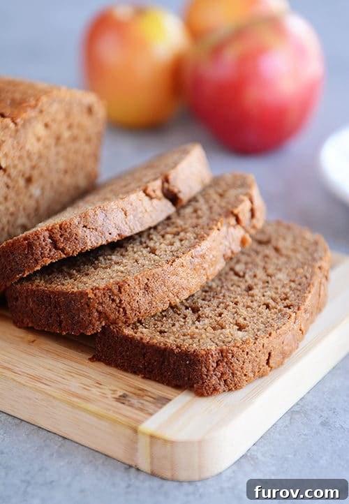 Hearty Cinnamon Apple Loaf 2 Thick, inviting slices of golden brown Whole Grain Cinnamon Applesauce Bread, revealing its tender crumb and delightful texture.