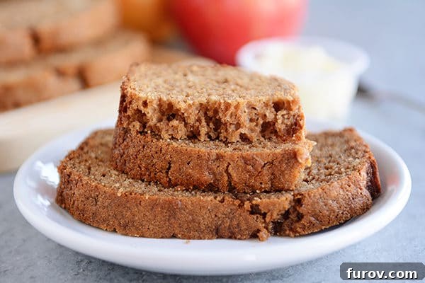 Hearty Cinnamon Apple Loaf 3 A stack of golden brown cinnamon applesauce quick bread slices, ready for serving.