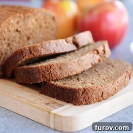 Hearty Cinnamon Apple Loaf 5 A perfectly baked loaf of Whole Grain Cinnamon Applesauce Bread, ready to be sliced.