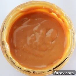 Dulce de Leche in the Instant Pot and Stovetop Pressure Cooker 11 A charming close-up of a jar of homemade pressure cooker dulce de leche, perfectly golden and inviting.