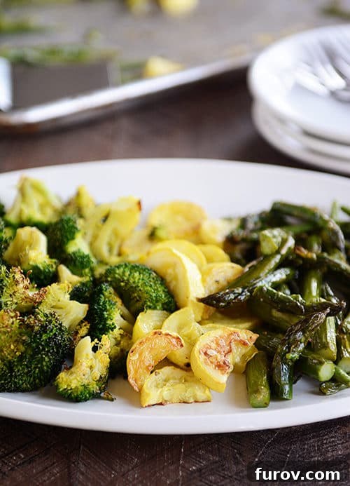 A platter of vibrant roasted broccoli, golden squash, and tender asparagus, showcasing the perfect caramelized texture.