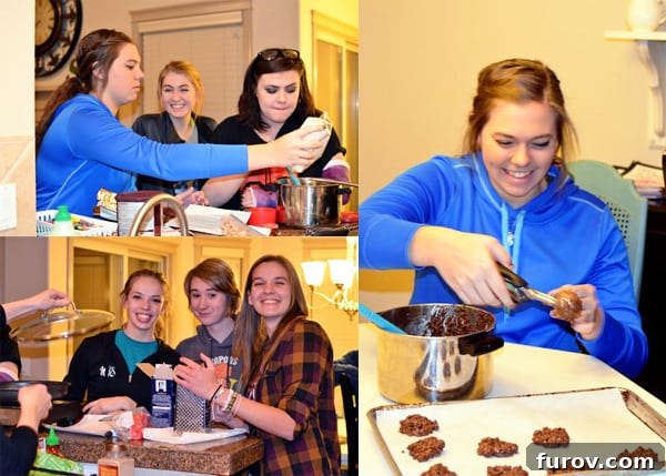 A group of smiling teenage girls enthusiastically making cookies together in a kitchen setting, demonstrating teamwork and enjoyment.
