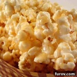 Golden Caramel Crunch Popcorn 3 Close-up of golden caramel popcorn in a wooden bowl