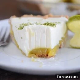 Zesty Key Lime White Chocolate Cheesecake Indulgence 5 Key Lime White Chocolate Cheesecake Pie with a slice taken out