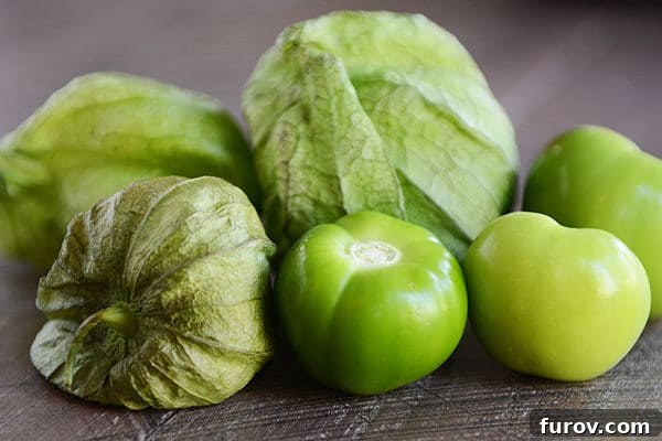 Fresh green tomatillos on a kitchen counter, ready for preparation.