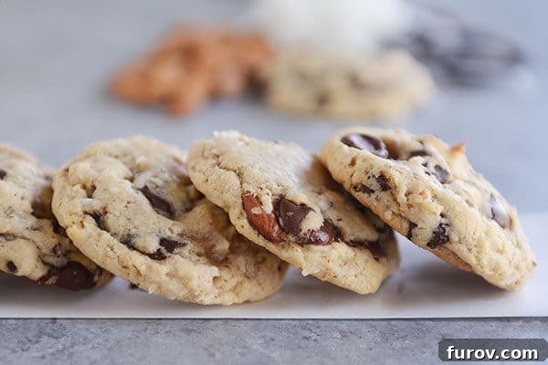 Almond and chocolate chunk cookies stacked side-by-side.